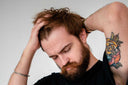 A guy running his hands through his hair.