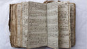 Handwritten diary pages from the 1700s, worn from years of daily use