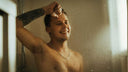 A guy in the shower smiling!