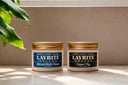 Layrite natural matte cream and cement clay on a bathroom sink