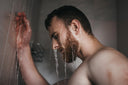 A man with a beard in the shower