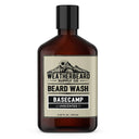 A 250 mL amber glass bottle of Weatherbeard Supply Co. Basecamp unscented beard wash with a black cap and a beige label, shown on a plain white background.