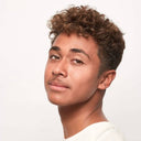 Person with styled hair on a plain background
