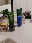 Bathroom counter with various skincare products including Jackfir and Heath.