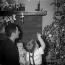 Our namesake with his two young sons looking at a Christmas tree.