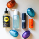 Four bottles of Byrd and Pretty Boy products with glittery eggs on a light background